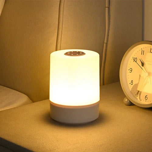 A warm bedside lamp glowing on a nightstand